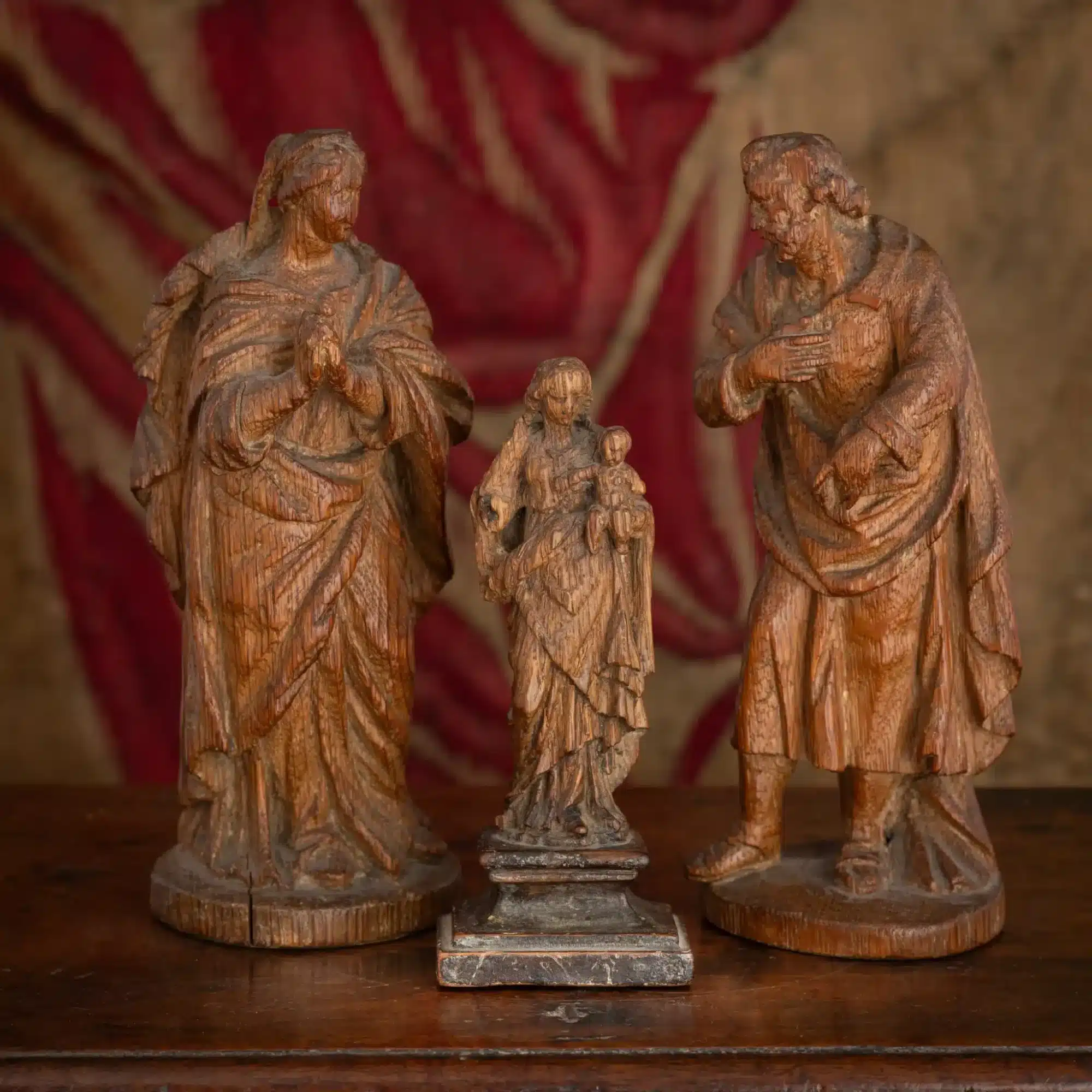 A Group of Three Small Oak Devotional Figures of the Holy Family