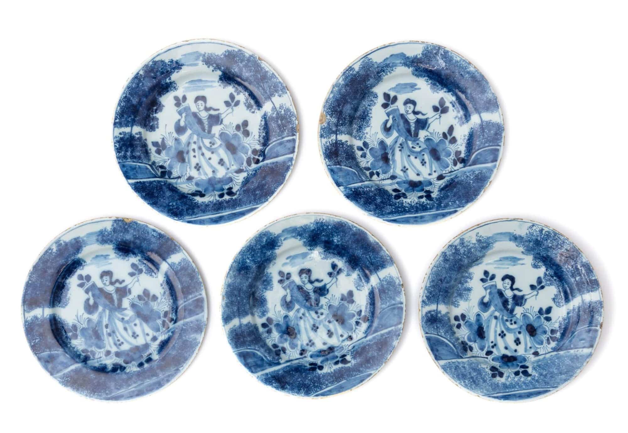 Set of Five English Delftware Plates Painted with a Lady in a Landscape