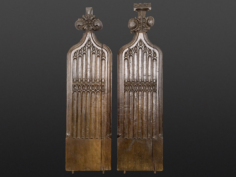 Late medieval English choir-stall ends with gothic tracery