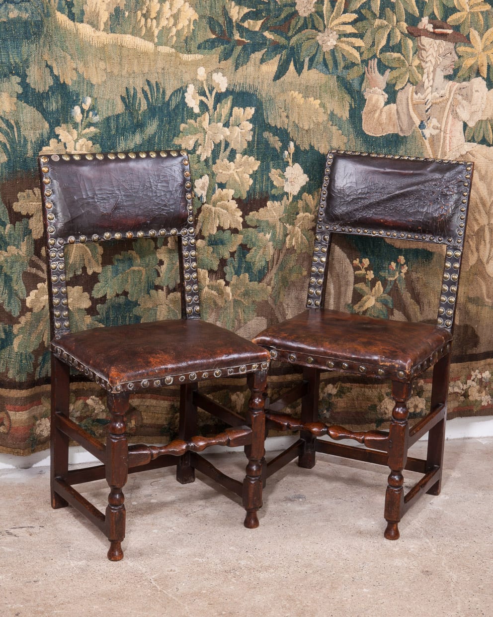 Pair of Charles II oak leather backstools