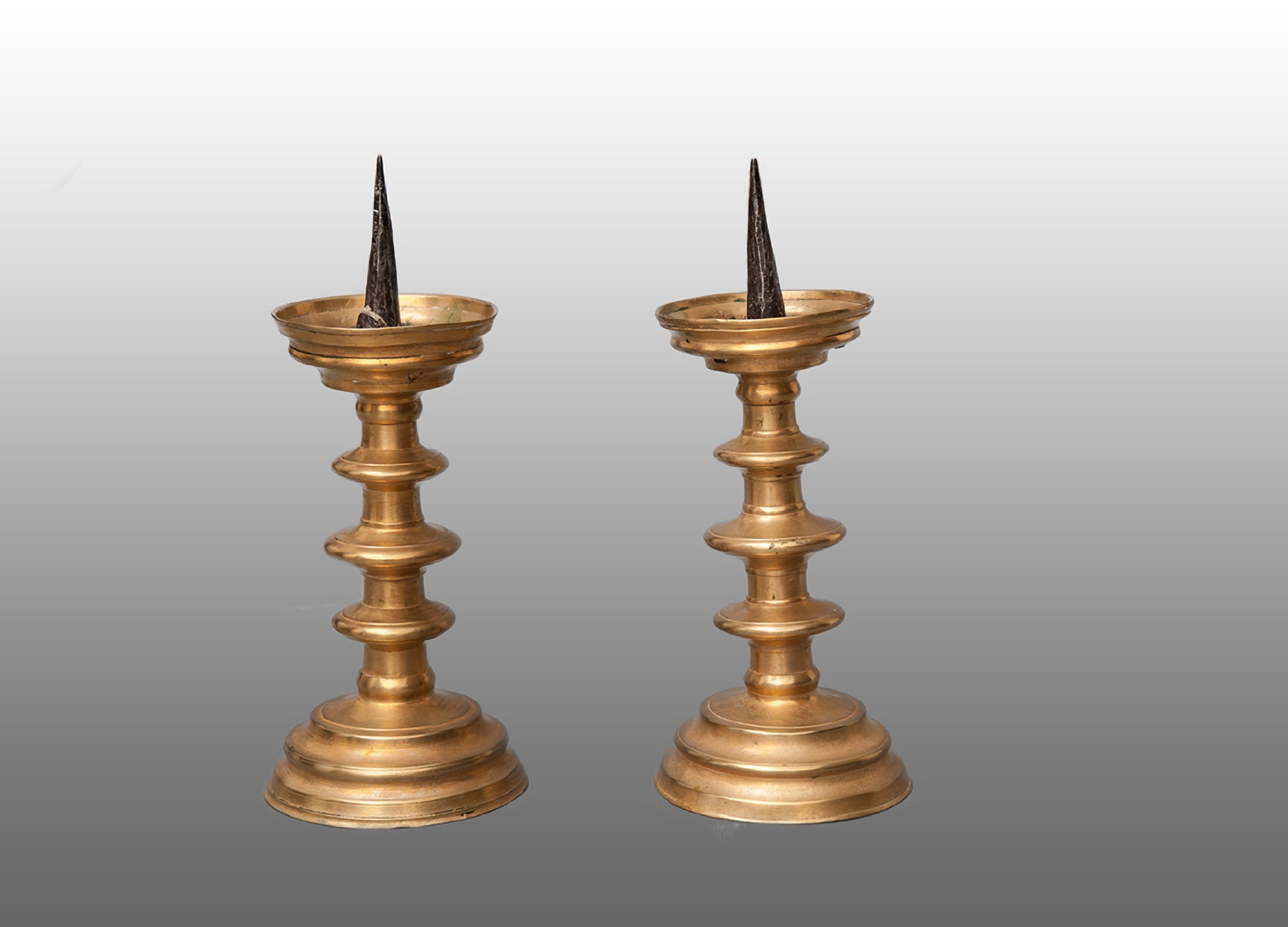 Pair of 16th century brass pricket candlesticks