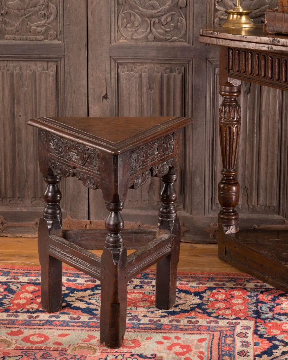 Triangular carved oak stool