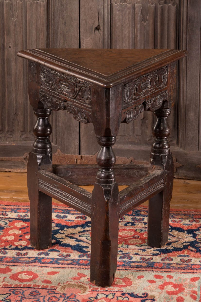 Triangular carved oak stool