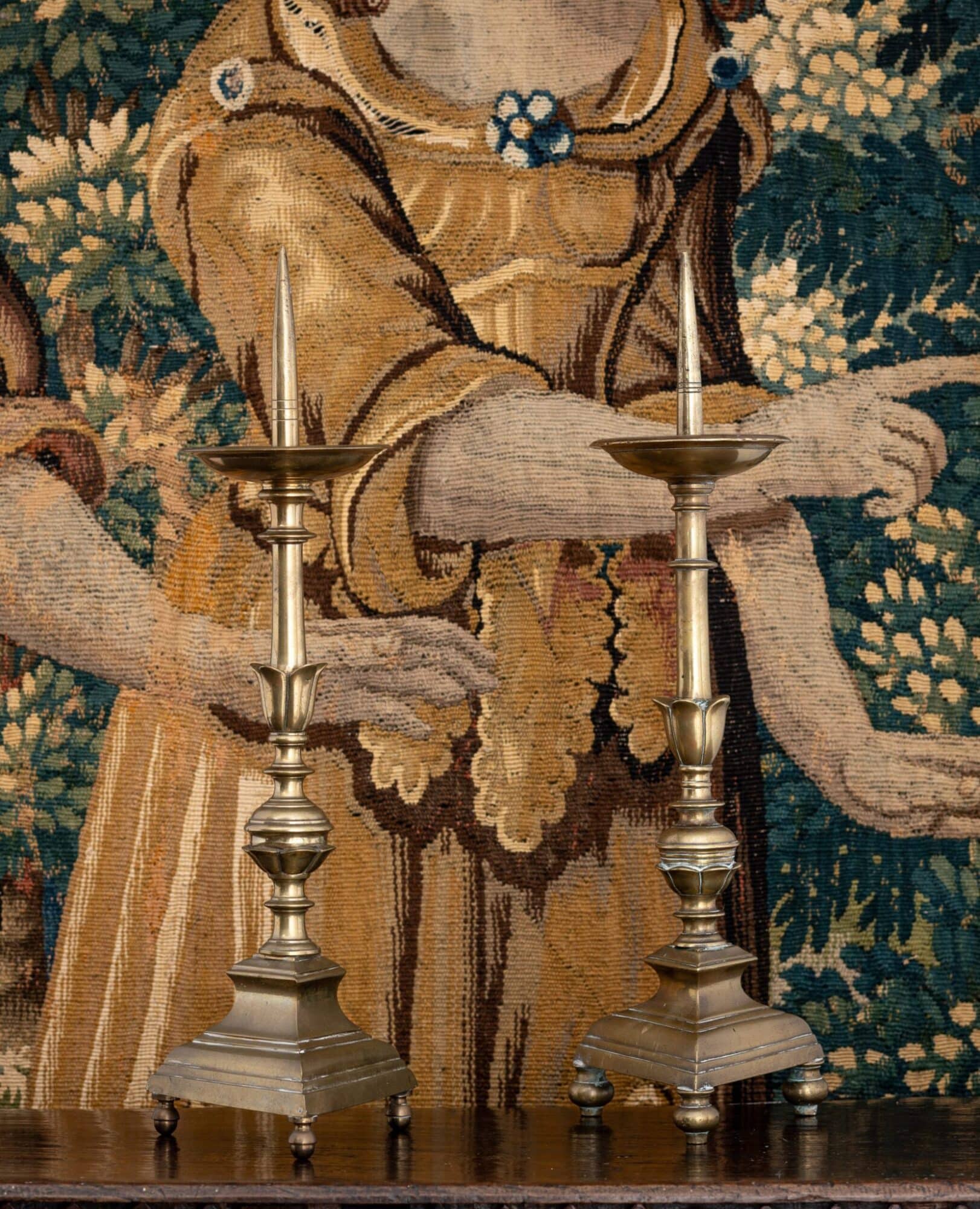 A matched pair of early 17th-century Italian brass pricket candlesticks