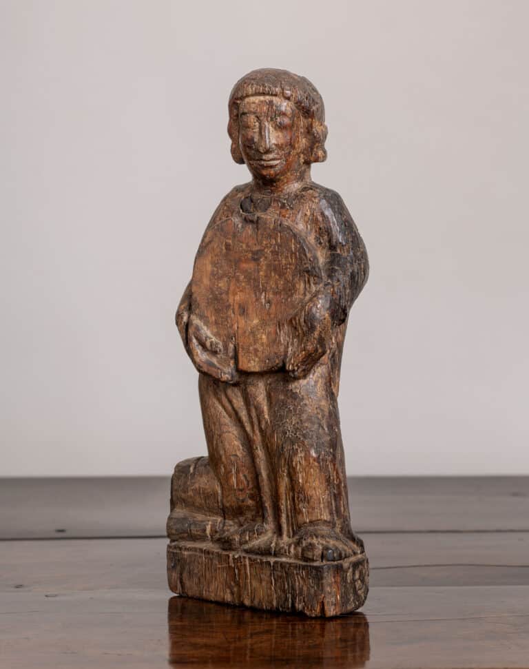 A Late Medieval Carved Oak Figure Holding a Roundel